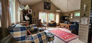 a living room with two couches and a table at Fidjeland 61 in Tjørhom