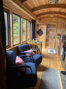 a living room with a couch and a table at Shepherd's Bothy, Bothan a Bhuachaille, Black Isle in Munlochy