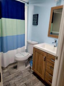 a bathroom with a toilet and a sink at Radiant Beach Block Condo Parking Patio in Brigantine +15 photos