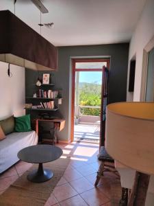 a living room with a couch and a table at La Maison De Stephanie in Porto-Vecchio