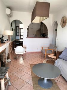 a living room with a couch and a table at La Maison De Stephanie in Porto-Vecchio +49 photos