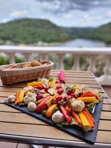 a plate of vegetables on a table on a table at Ma villa au bord de l'eau in Miremont