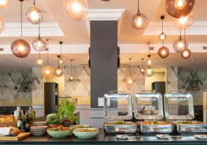 a buffet of food on a counter in a kitchen at Crowne Plaza Antwerpen by IHG in Antwerp