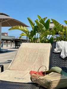 a table with a towel and a basket on it at Silken Ramblas in Barcelona