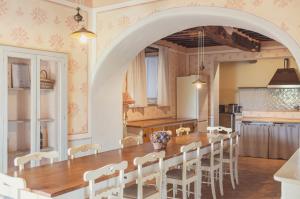a kitchen and dining room with a wooden table and chairs at Tregole in Castellina in Chianti