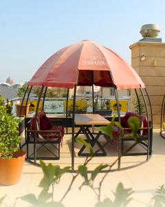 a table and chairs under an umbrella on a patio at Atropat Old City Hotel in Baku +83 photos