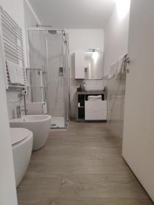 a white bathroom with a shower and a sink at Apartments Del Mare, Famagosta, Parking, Forum in Milan +17 photos