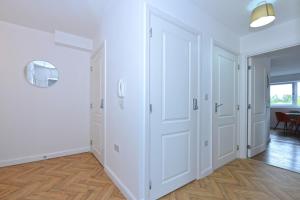 an empty room with white walls and white closets at Broad Gauge Apartments in Wolverhampton