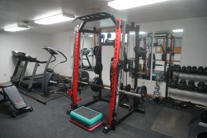 a gym with several tread machines in a room at Malta Edgewater Inn and RV Park in Malta