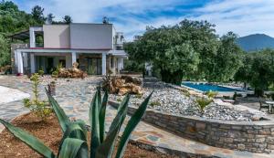 a villa with a swimming pool and a house at Ipsario Garden Hotel in Skala Potamias