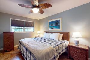 a bedroom with a bed and a ceiling fan at Laze Away in Fort Myers Beach +34 photos