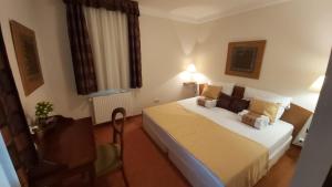 a hotel room with a bed and a chair at Andante apartman in Bük