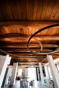 a room with wooden ceilings and tables and chairs at Borgo Capietaglio Wine Resort in Gromlongo +21 photos