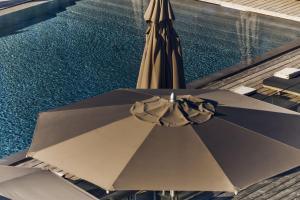 an overhead view of an umbrella next to a swimming pool at Hôtel Plage Palace & Spa in Palavas-les-Flots