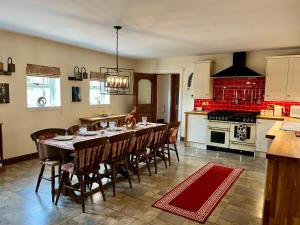 a kitchen with a table and chairs in a room at Starshinezzz - Large Farmhouse County Durham in Trimdon Grange +18 photos