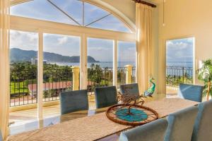 a dining room with a table and a large window at Acqua 801 in Jacó