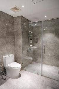 a bathroom with a toilet and a glass shower at Best Western Premier Sapphire Hạ Long 2BR Homestay 55m2 in Ha Long +20 photos