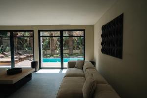 サントロペにあるLa Vague - Saint Tropezのソファのあるリビングルームと外のプール