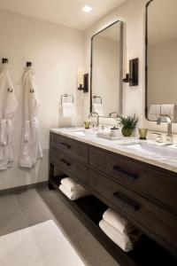 a bathroom with two sinks and a large mirror at The Sylvan Lodge at Snake River Sporting Club in Jackson