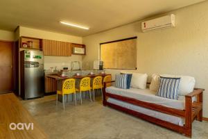 a kitchen with a couch and chairs in a room at Qavi - Casa com Piscina Privativa - Lambari 07 in Barra do Camaragibe