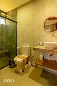 a bathroom with a toilet and a sink and a shower at Qavi - Casa com Piscina Privativa - Lambari 07 in Barra do Camaragibe