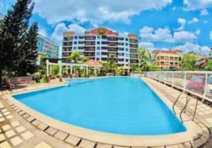 a large swimming pool in front of a hotel at Davao Condo Chateau Soleil in Davao City
