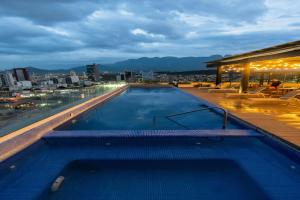 a swimming pool on the roof of a building at SJ Grand Hotel in Monterrey