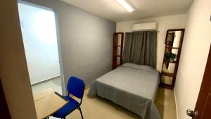 a small bedroom with a bed and a desk and a chair at Hostal TO3 in Ciudad Madero +7 photos
