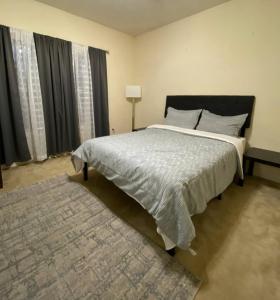 a bedroom with a large bed and a rug at Private Getaway with Balcony in Columbus