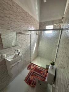 a bathroom with a toilet and a sink at Casa da praia Ilha Grande in Camamu