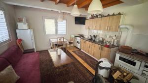 a kitchen with a couch and a table and a refrigerator at Guest House Skakavac in Sarajevo
