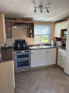a kitchen with white cabinets and a stove top oven at Number 51 in Arbroath
