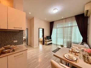 a kitchen and a living room with a table at My hip Condominium 2 Bedrooms 2 baths comfy room for family in Chiang Mai