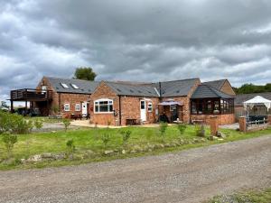 a brick house on the side of a road at Starshinezzz - Large Farmhouse County Durham in Trimdon Grange