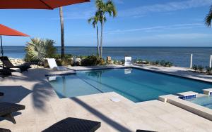a swimming pool with a view of the ocean at Seascape Point in Marathon