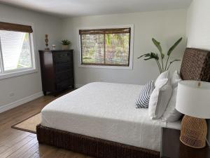a bedroom with a bed and a dresser and a window at Seascape Point in Marathon +18 photos