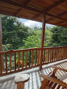 a wooden porch with a view of trees at Finca Colibri Ecolodges en Pleine Nature ferry Playa Najanjo Costa Rica in Cabo Blanco