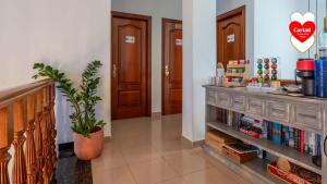 a hallway with a book shelf and two doors at Cariad Boutique Bed & Breakfast in Cala del Moral +31 photos