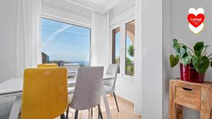 a dining room with a table and chairs and a window at Cariad Boutique Bed & Breakfast in Cala del Moral +32 photos