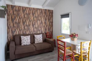 a living room with a couch and a table at Agriturismo Macchia di Riso in Nova Siri Marina