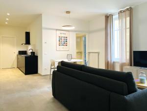 a living room with a couch and a table at Casa FILA1923 in Biella