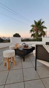 a patio with a table and chairs on a roof at Villa Carma in Kos