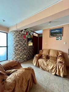 a living room with two beds and a couch at Hostal Pukayaku San Luis in San Luis