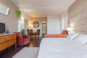 a bedroom with a bed and a living room at Estoril na praia in Estoril