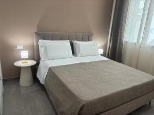 a bedroom with a large bed and a side table at A due passi in Balestrate