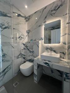 a bathroom with a toilet and a sink and a mirror at Douskos Guesthouse in Hydra +105 photos