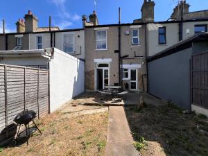 a backyard of a house with a grill at Abbey Wood Residence in Abbey Wood