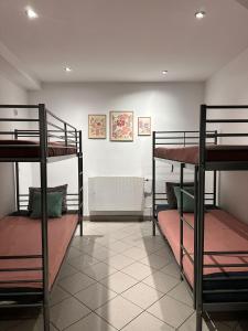 a room with three bunk beds in it at Gołębia Group Room in Poznań