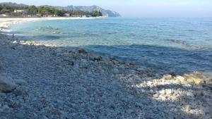 a large group of rocks on the shore of a beach at Affittacamere di Ilir in Ancona +4 photos