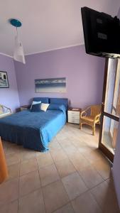 a bedroom with a bed and a flat screen tv at Villa Diamante in Diamante